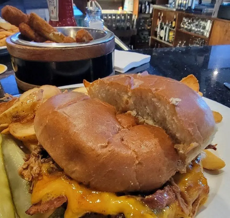 A Bulldogs burger with melted cheese and fries