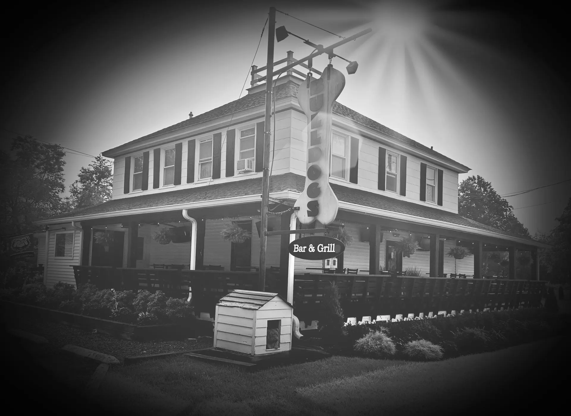 Bulldogs Bar and Grill, a two-story neighborhood pub with a covered porch
